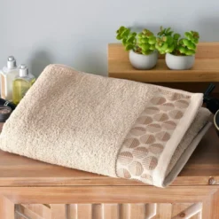 BecquetLot de 2 gants de toilette en coton beige avec liteau cercle - EP. SERVOPTIQUE